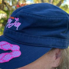 a woman wearing a blue hat with pink lipstick on it