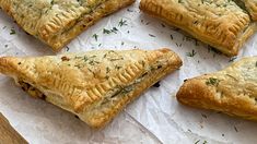 several pastries are arranged on wax paper