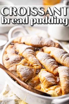 croissant bread pudding in a white dish with a wooden spoon on the side