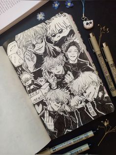 an open book with anime characters drawn on it next to markers and pencils in front of them