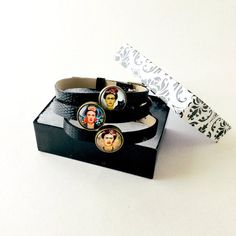 So delightful Frida Kahlo-Inspired Leather Bracelet Set with adjustable straps.Displays three images of the international Mexican icon Frida Kahlo.Theme: PunkMaterial: Faux LeatherMetal: AllowColor: Black LeatherStyle: BangleBracelet chain length: Approx. 6.5 inchGlass Diameter: 0.55 inchThis is an excellent gift idea! They come in a beautiful and elegant gift box. Order Now! Limited Quantities/Limited Edition.Get them fast... ready to ship in one to three business days. Thank you for shopping w Punk Style Adjustable Leather Bracelet, Adjustable Leather Punk Bracelet, Adjustable Punk Style Leather Bracelet, Adjustable Punk Style Bracelet For Gift, Adjustable Punk Style Bracelets As A Gift, Adjustable Black Band Leather Bracelet, Elegant Gift, Chain Lengths, Bracelet Set