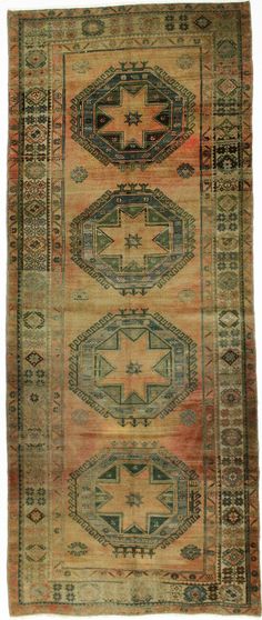 an antique rug with different colors and patterns