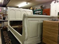 a white bed frame sitting on top of a rug