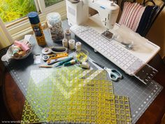 the sewing machine is sitting on top of the table next to some crafting supplies