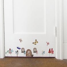 the door is decorated with butterflies and houses