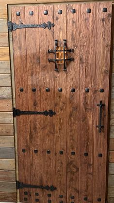 an old wooden door with iron bars on it