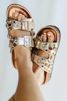 These Azalea Wang Bayleaves Gem Slides for Women in Gold will be your new go-to sandals this summer! Featuring a trending stud detailing and a cork footbed, these sandals will make you standout while staying comfortable! Features: Azalea Wang Style: BAYLEAVES-GOLD Color: Gold with Rhinestones Women’s sandals Two bands across vamp with buckles Multi colored gem embellishments Cork Footbed Round, open toe Azalea Wang brand on heel bed Measurements from size 6: Heel: 1/2" Modern Blouse Designs, Bed Measurements, Colorful Sandals, Check Blouse, Western Blouse, Woman In Gold, Gold Slides, Colored Sandals, Slides For Women