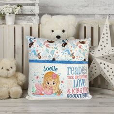 two teddy bears are sitting next to a pillow