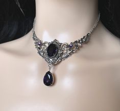 "Choker: This elegantly ornate necklace is made with antique silver tone centerpieces, featuring lavish baroque details. Its mesmerizing design is accented with dazzling deep violet purple glass crystals/jewels. Decorated portion is 4\" wide and 2 1/2\" tall in the very center. Necklace length is adjustable 14\"-17\" with soldered stainless steel cable chain, lobster clasp and extender. If you would like a different length, please send us a message. Earrings: These dainty and elegantly ornate ea Black And Purple Jewelry, Dark Purple Jewelry, Baroque Details, Labyrinth Ball, Gothic Antique, Ornate Necklace, Purple Choker, Purple Goth, Cottagecore Jewelry