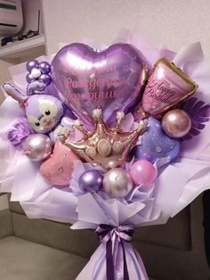 a bouquet of balloons and stuffed animals in the shape of hearts