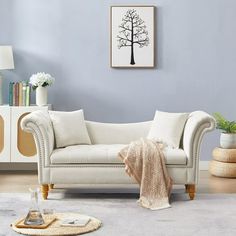 a living room with a white couch and table