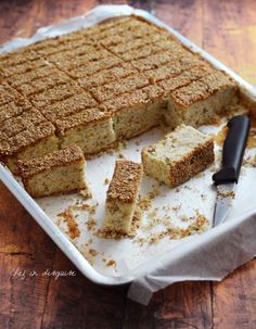 the cake is cut and ready to be served on the table with a knife next to it