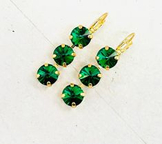 Majestic Green Triple Stone Drop Crystal Earrings, Christmas Green Crystal Earrings. Christmas Green Triple Stone Earrings, YOU CHOOSE METAL THE HOLIDAY COLLECTION: Crystal Drop Earrings - HANDMADE BY JKCAROLINA Custom Orders Available - Other Stone Colors available - Message Me * 3 stone 8mm earrings - green * yellow gold plated metal - antique silver is available * very popular colors * top quality European components * made with genuine Crystal elements * prongs do not snag on clothes * jewelry bag included * all jewelry designed and created by me the owner of JKCAROLINA LLC. *CUSTOM ORDERS are available.  Please contact me if you would like different colors or if you have any questions.   FIND ME:  https://www.etsy.com/shop/jkcarolina  http://facebook.com/jkcarolinajewelry  EXCELLENT C Christmas Green, Earrings Christmas, Earrings Green, Popular Colors, Green Crystal, Crystal Drop Earrings, Crystal Drop, Green Crystals, Holiday Collection