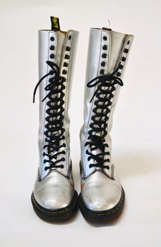 "Made in England by Dr. Martens Made in England by Dr. Martens Silver metallic leather Print Combat boots Size -VTG Size 4 UK US Womens aprx 6 Leather upper Rubber souls 10 3/8\" length outer sole 9 1/8\" length inner sole 4\" width outer sole 3 3/4\" width inner sole Shaft Height 12 1/2\" from heel Used Vintage condition with below points * wear/scuffs on outside of shoe where the silver has worn * Some wear on the inside of the insoles * Some wear on the soles * Lots of life in them! Price is Knee-high Combat Boots With Laces For Fall, Fitted Leather High-top Knee-high Boots, Fitted Winter Boots With Lacing, Fitted Knee-high Combat Boots For Fall, Fall Knee-high Laced Boots, Leather Knee-high Boots With Lacing, Trendy Knee-high Moto Boots, Winter Knee-high Lace-up Boots, Trendy Fitted Knee-high Lace-up Boots