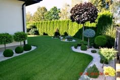 an outdoor garden with grass and trees