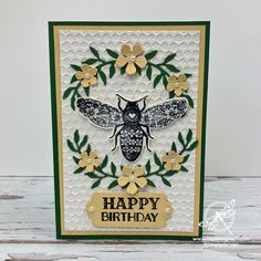 a card with a bee and flowers on it