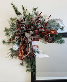 a christmas wreath hanging on the side of a door