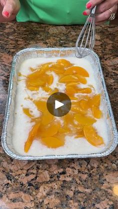 a woman is mixing some food in a pan