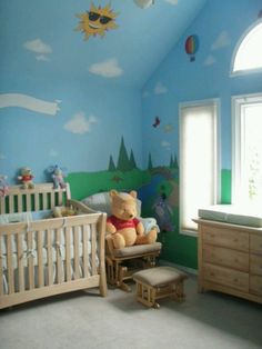 a child's bedroom with a teddy bear in the crib