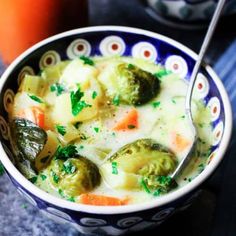 a bowl of soup with broccoli and carrots