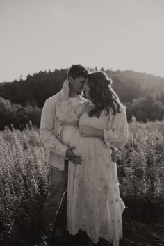 black and white photograph of a pregnant couple