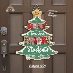 a christmas tree shaped door hanger on a brown front door with the words merry teacher's day and mrs smith