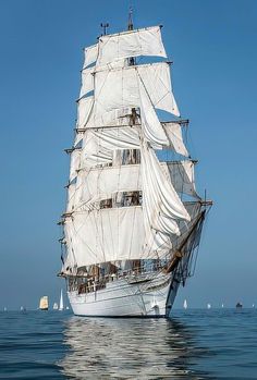 an old sailing ship in the middle of the ocean