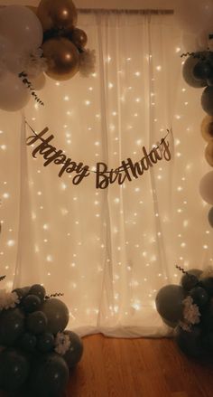 a birthday backdrop with balloons and lights