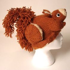 a knitted hat with a pom - pom attached to the top of it