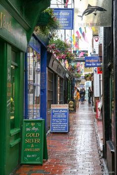 an alley way with shops and signs on it