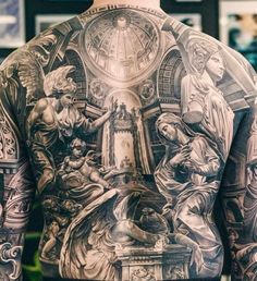 the back of a man with tattoos on his body