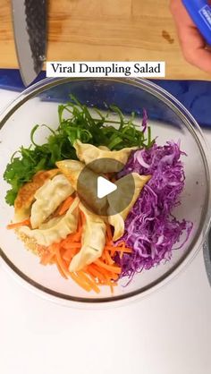 a bowl filled with vegetables and dumplings next to a knife