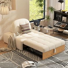 a living room with a white couch and black and white rugs on the floor