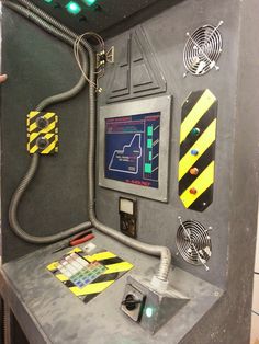 a machine that has some kind of electronic device on top of it, with other items around it