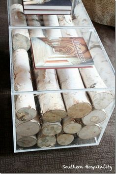 there are many logs stacked on top of each other in this display case with glass shelves