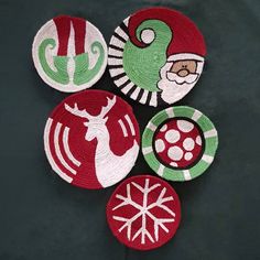 four woven coasters with designs on them sitting next to each other in front of a black background