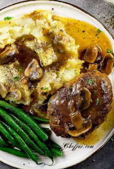 a plate with mashed potatoes, green beans and mushrooms