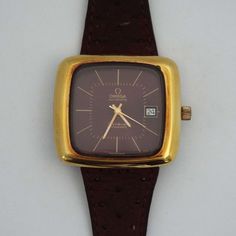 Rare Omega Geneve Automatic TV shape wristwatch. Analogue. 1970's. Rich maroon/brown dial. Dark brown suede strap. Gold capped over stainless steel. Stainless steel back. Original crown. Diameter 40mm excluding crown. In good vintage working condition. Last serviced approximately 15 months ago. Small nick in the gold cap top right corner and feint scratch to plexi top left corner. Strap is a replacement and has a feint mark on one side. Any questions please ask. Thank you for looking. Vintage Brown Watch Accessories With Rectangular Dial, Brown Rectangular Dial Analog Watch, Brown Watches With Rectangular Analog Display, Brown Watch With Rectangular Analog Display, Brown Watch With Rectangular Dial And Analog Display, Brown Chronometer Watch With Rectangular Dial, Vintage Brown Watch With Rectangular Dial, Vintage Brown Watch Accessories For Formal Occasions, Vintage Brown Formal Watches