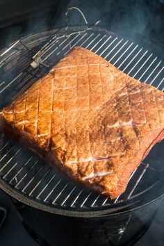 a piece of steak is cooking on the grill