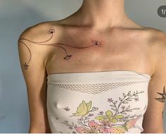 a woman with a flower tattoo on her chest