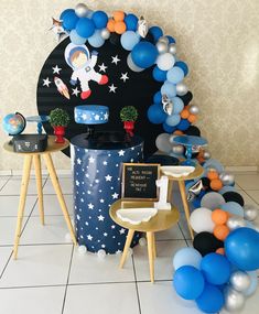 an astronaut themed party with balloons and decorations