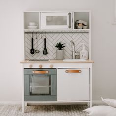 a kitchen with white cabinets and wooden counter tops, including an oven in the center