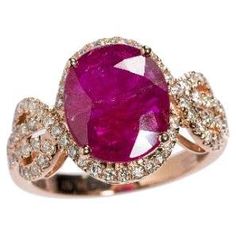 Prepare to be enchanted by this exceptional IGI Certified 4.02 Carat Ruby Ring. Crafted in luxurious 18K rose gold, this exquisite ring showcases an oval-shaped Ruby of intense deep purplish-red hue, radiating elegance and allure. The focal point of this captivating ring is the IGI Certified oval Ruby, expertly cut to perfection and boasting a remarkable 4.02 carat weight. Its vivid deep purplish-red color captures attention and exudes a sense of passion and mystique. Held securely in a prong setting, the Ruby takes center stage, captivating all who behold it. Surrounding the central Ruby are 70 round brilliant diamonds, adding a breathtaking touch of sparkle and elegance. Weighing a total of 0.50 carats, these diamonds are impeccably set in a modern style, creating a harmonious blend of c Ruby Diamond Ring, Ruby And Diamond Ring, Ruby Diamond Rings, Rose Gold Band, Modern Ring, Rare Gemstones, Everyday Accessories, Fine Jewels, Ruby Diamond