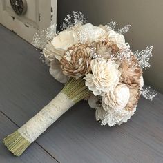 a bridal bouquet with white flowers on a table