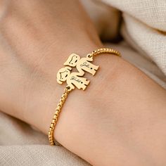 Celebrate the joy of childhood with our Personalized Charm Engraved Gold Plated Bracelet. This delightful piece captures the innocence and wonder of youth with its whimsical girl and boy silhouette charms. Crafted with care, this bracelet is made from 18K gold plated stainless steel, ensuring it is durable, waterproof, and hypoallergenic. It's a lasting treasure designed to withstand the active, playful days of childhood. Each charm, measuring 23.5mm x 20mm, can be personalized with a special da Name Charm Bracelet For Friendship, Jewel Bracelet, Boy Silhouette, Bracelet Initial, Girl And Boy, Simple Bracelets, Gold Plated Bracelets, Playful Design, Charm Bracelets