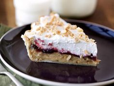 a piece of pie sitting on top of a black plate