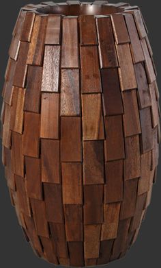 a vase made out of wooden pieces on a gray background