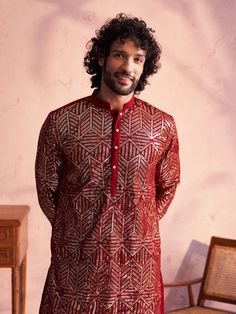 Shrestha by Vastramay - Men's Maroon Georgette Embellished Kurta Patiala Set Look dapper in this festive kurta patiala set. Made from luxurious georgette, the kurta features a mandarin collar, long sleeves with embellishments, and a straight knee-length cut. The solid cream patiala with an elasticated waistband completes the look. Perfect for weddings, parties, and other special occasions. Key Features Maroon georgette kurta with embellishments Mandarin collar Long sleeves Straight knee-length c Traditional Embellished Transitional Kurta, Embellished Long Sleeve Bandhgala For Festivals, Traditional Embellished Kurta For Festivals, Traditional Embellished Kurta For Eid, Traditional Embellished Kurta For Navratri, Transitional Party Kurta With Gota Work, Eid Party Bandhgala Straight Kurta, Festive Party Bandhgala Straight Kurta, Sequin Traditional Wear For Party In Transitional Season