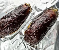 two eggplant halves sitting on aluminum foil