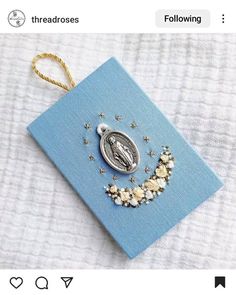 an ornament is hanging on a blue book with stars and moon decorations around it